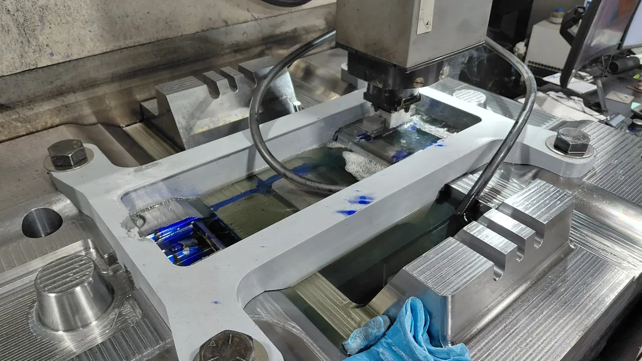 Close-up of the custom tank surrounding a workpiece in the EDM