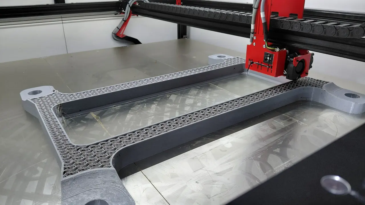 Gray EDM tank during printing, with its internal infill visible