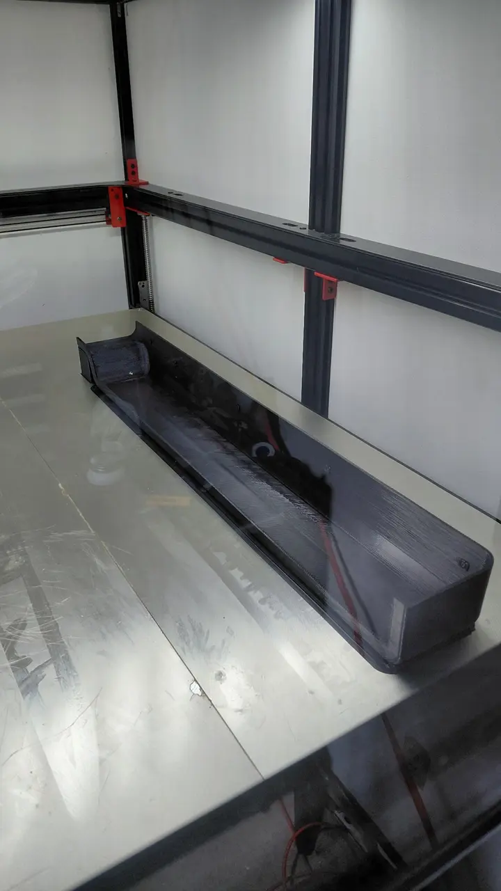 Long black recreated semi-truck part on the large-format printer bed